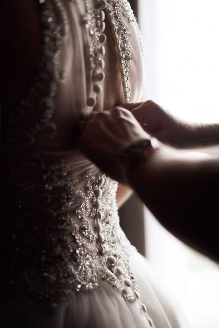 buttoning back of wedding dress