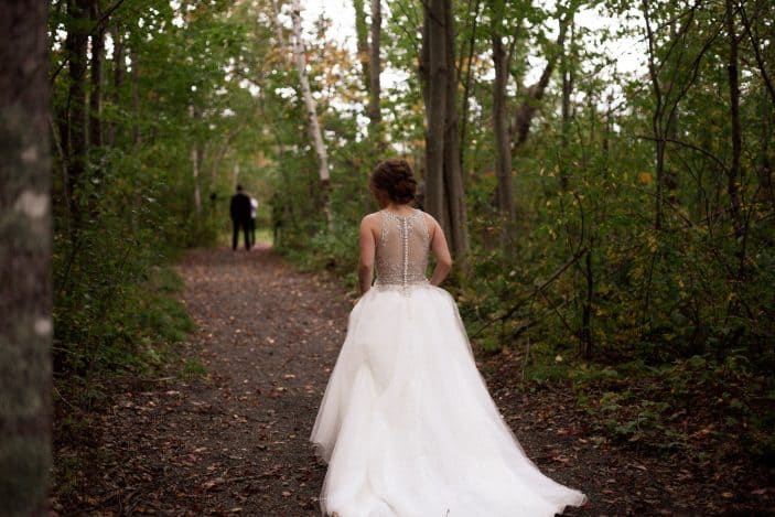 Our rustic chic and cozy fall wedding - bride walking in the forest