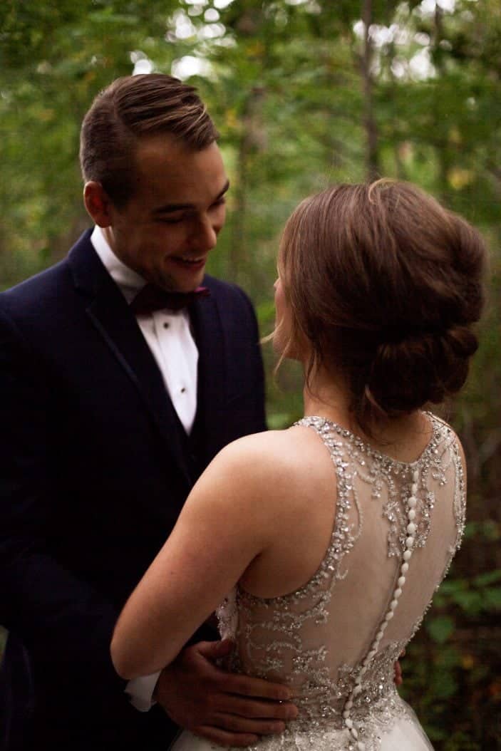 Our rustic chic and cozy fall wedding groom looking at bride