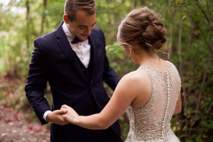 Our rustic chic and cozy fall wedding groom looking at bride