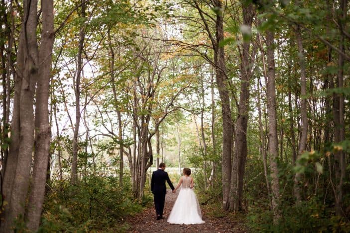 bride and groom walking in the forest