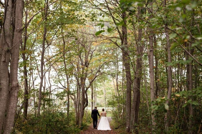 Our rustic chic and cozy fall wedding - bride and groom walking in forest