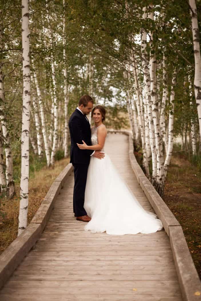 bride and groom holding each other - cozy fall wedding