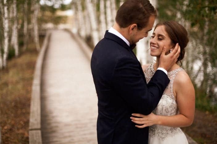 groom looking at bride laughing - cozy fall wedding