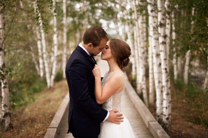 bride and groom kissing - cozy fall wedding