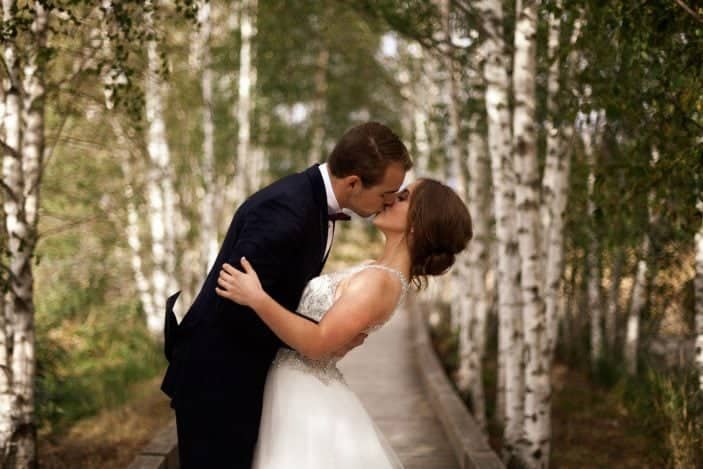 bride and groom  kissing - cozy fall wedding