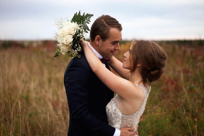 bride and groom in a field - wedding photos