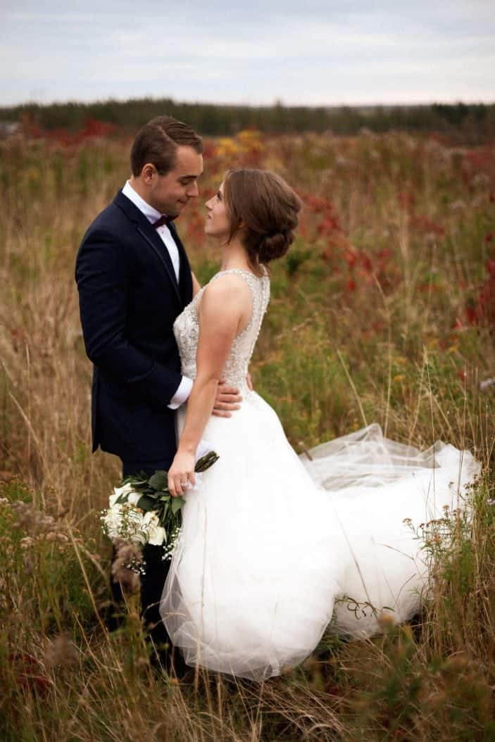 bride and groom in a field