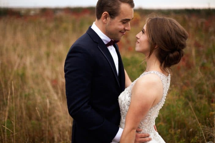 bride and groom in a field - wedding photos