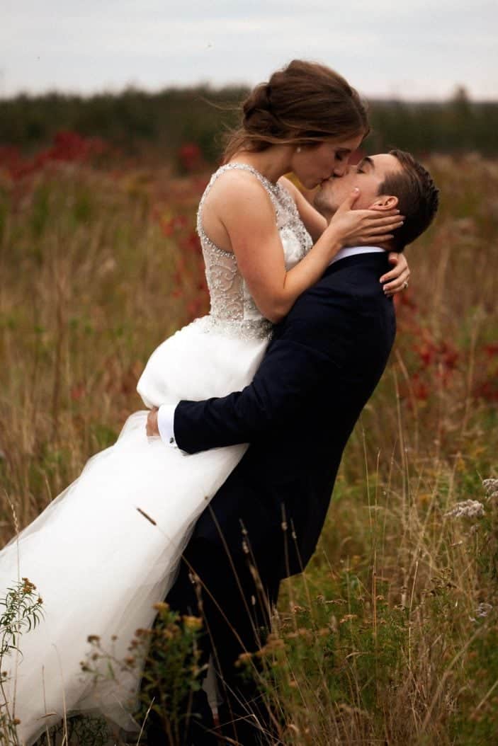 groom holding bride, kissing - wedding photos