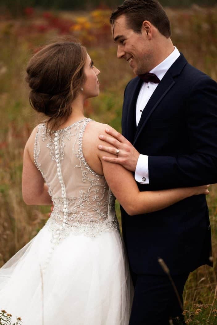 bride and groom smiling at eachother - wedding photos