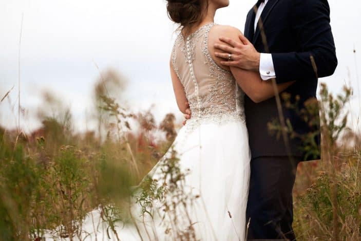 bride and groom in a field - wedding photos