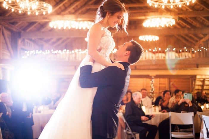 groom lifting bride during first dance