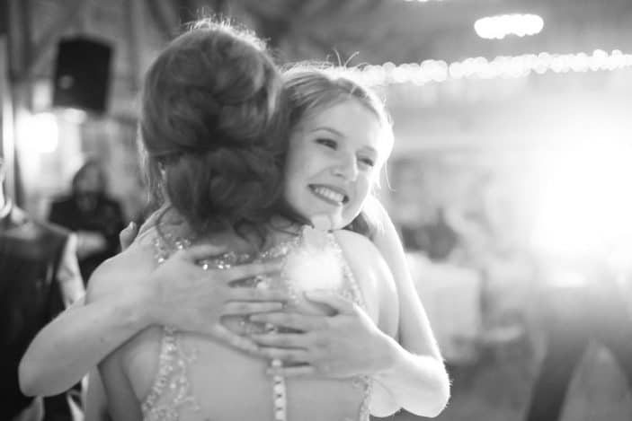 bride and bridesmaid huging