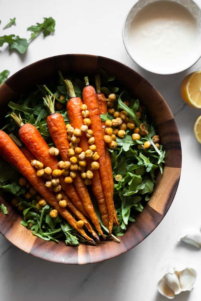 arugula, roasted carrots and chickpeas in a bowl