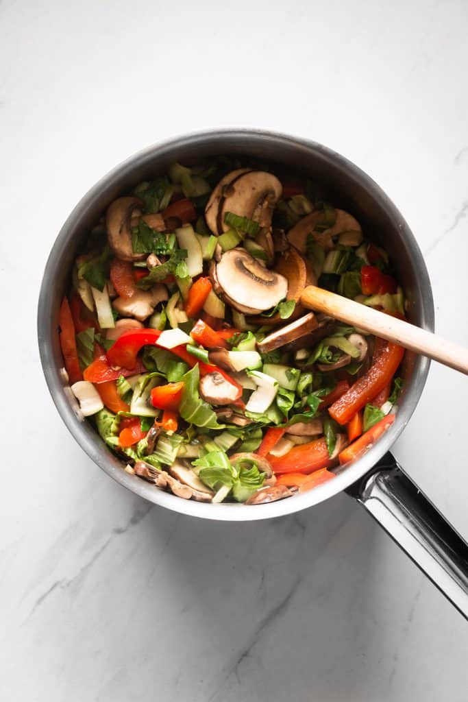 mushrooms, peppers, bok choy in a saucepan