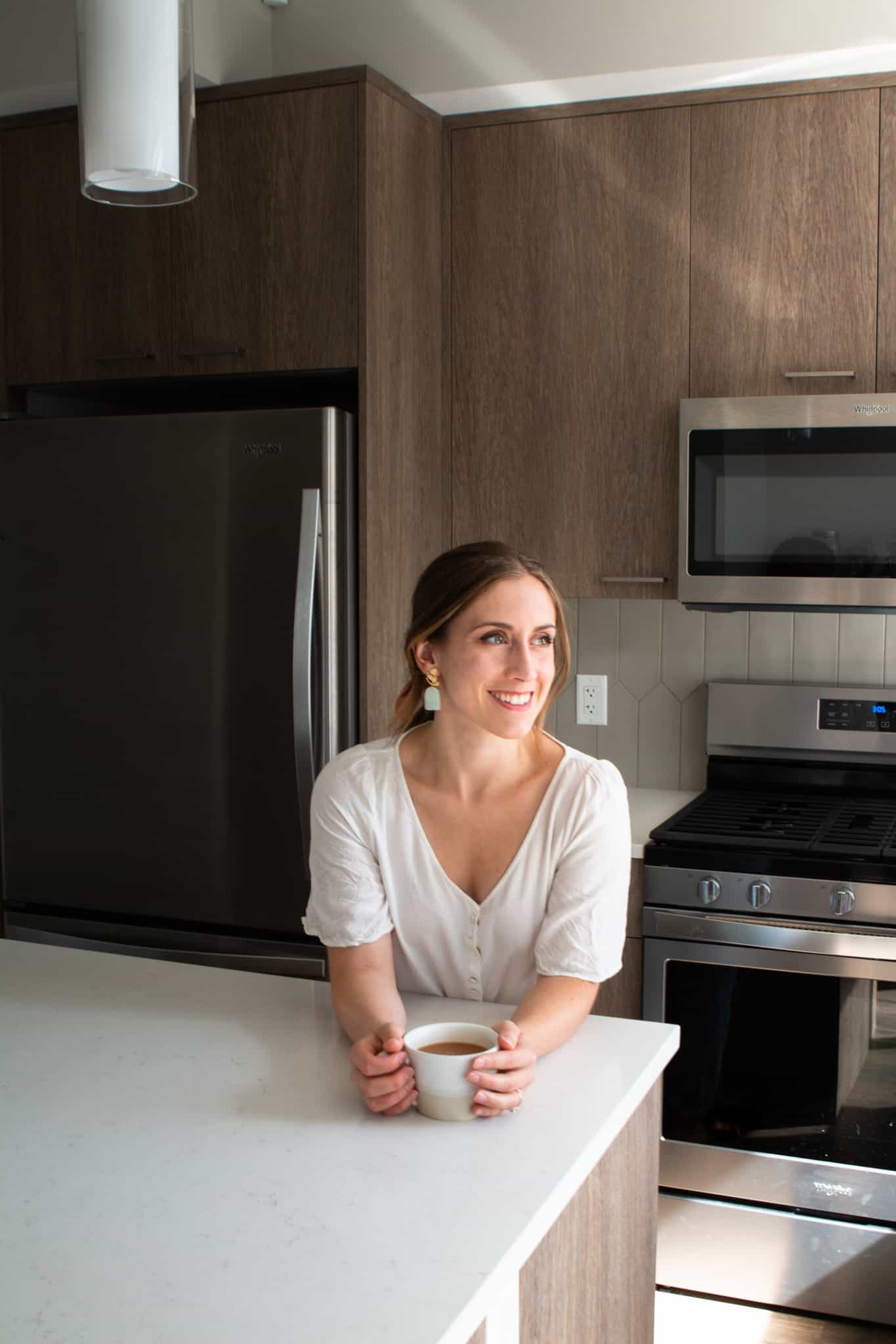 girl in kitchen with cup of tea