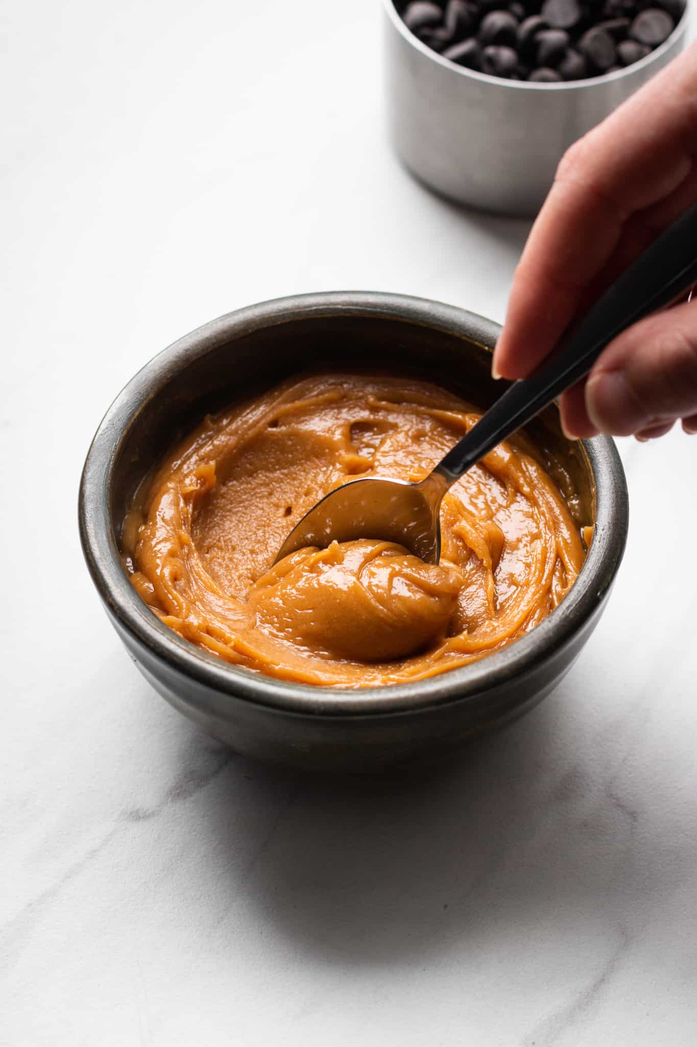 spoon scooping caramel in a bowl