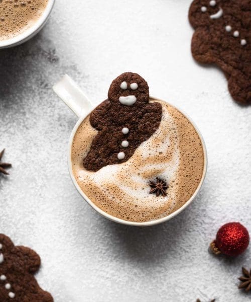 gingerbread latte in a cup with gingerbread men