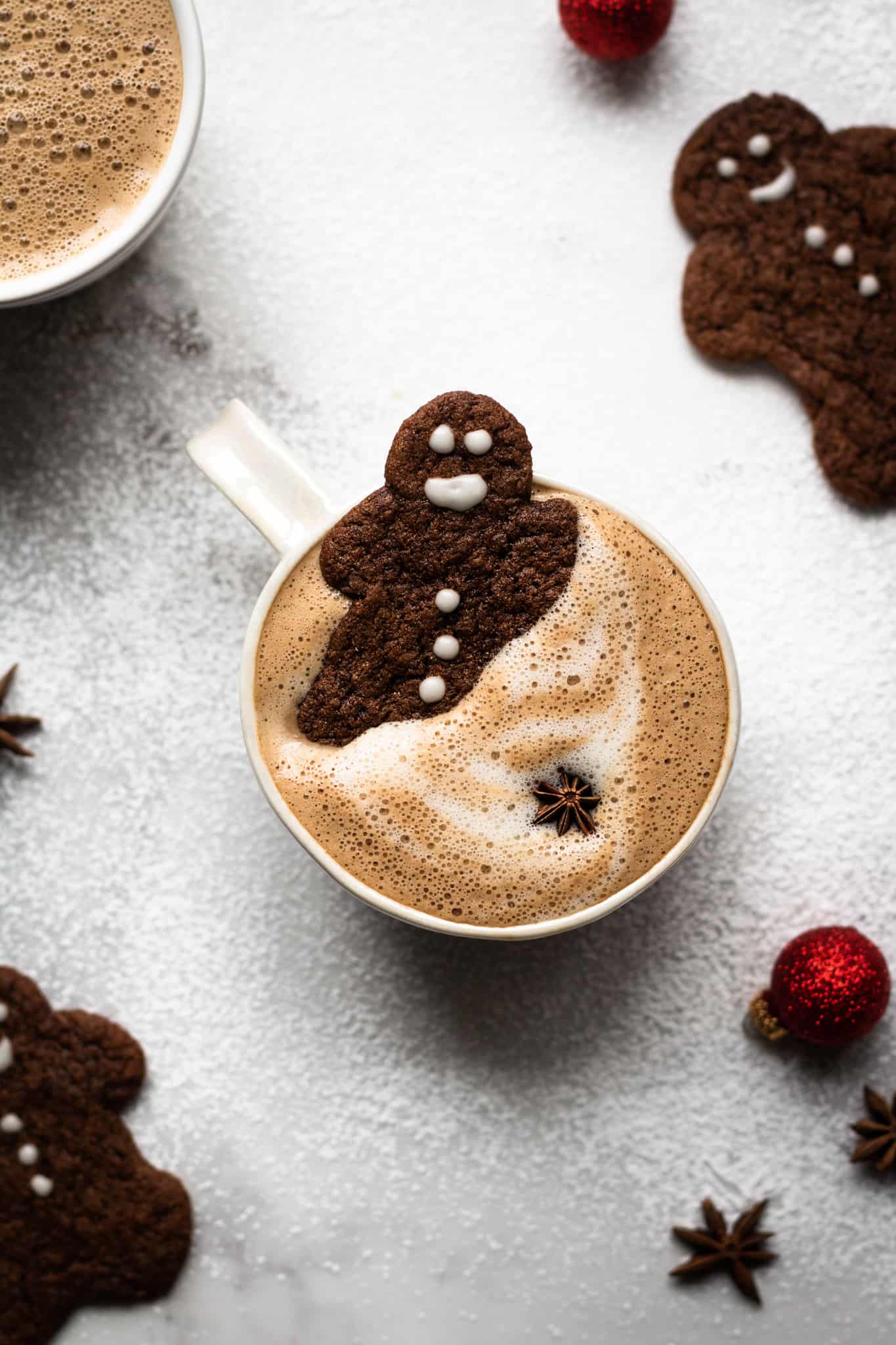 vegan gingerbread latte with gingerbread cookie dipped in
