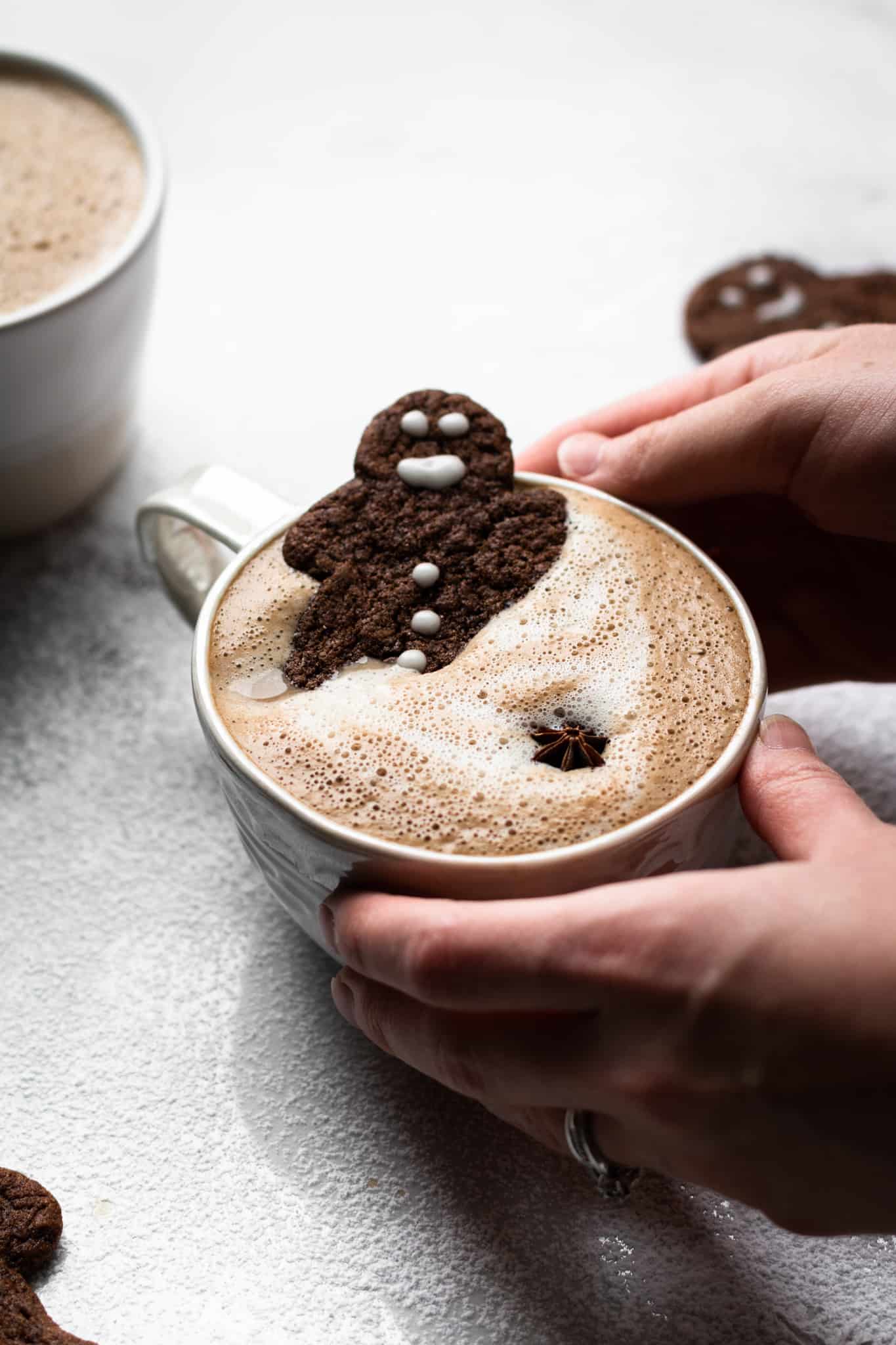 hands holding a cup of gingerbread latte