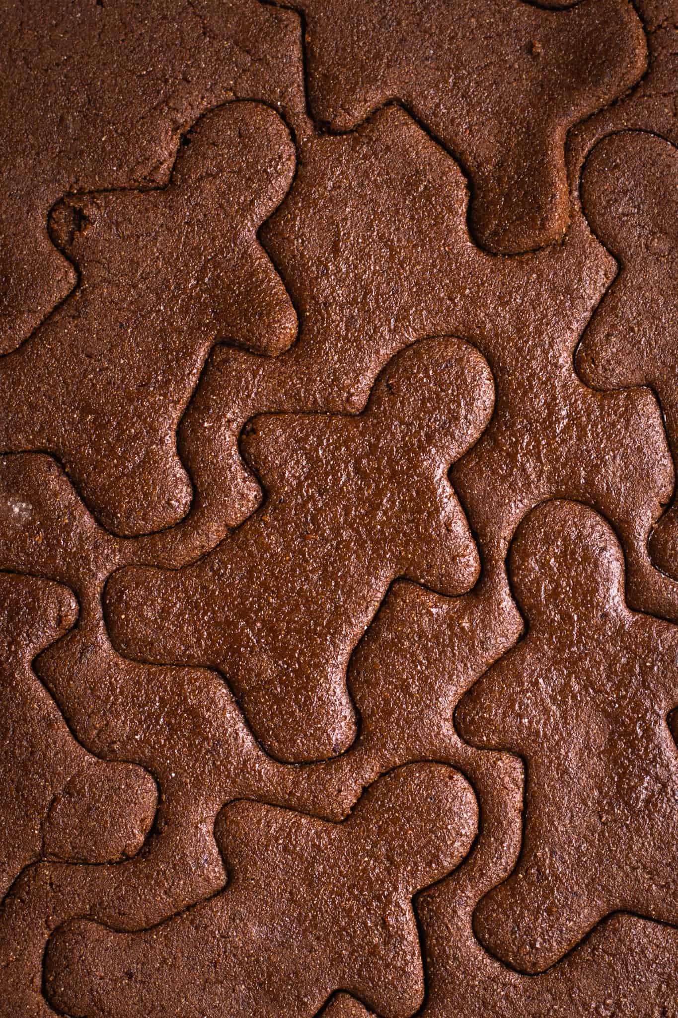 closeup of gingerbread dough cut into cookies