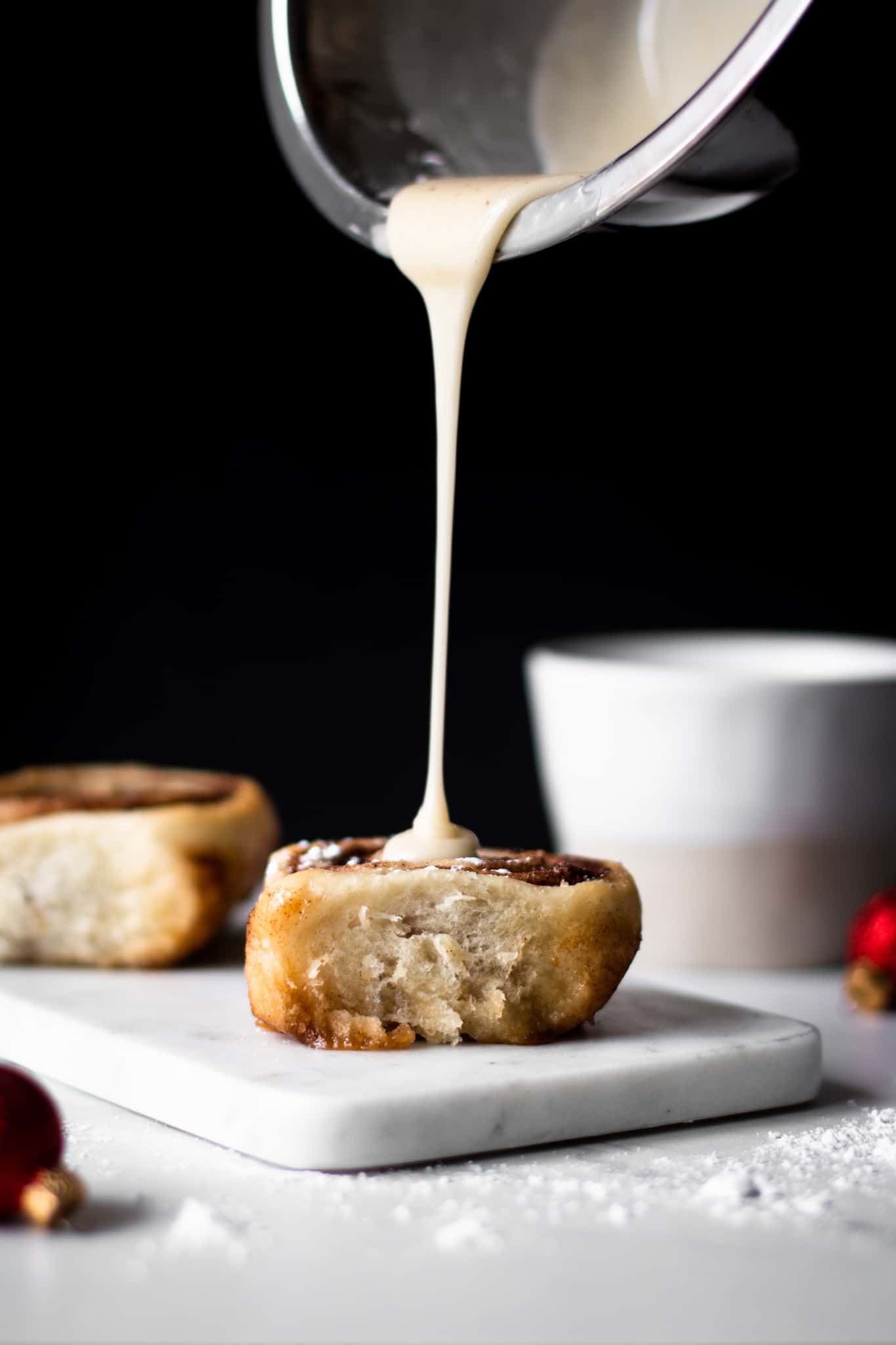 Icing poured over cinnamon roll