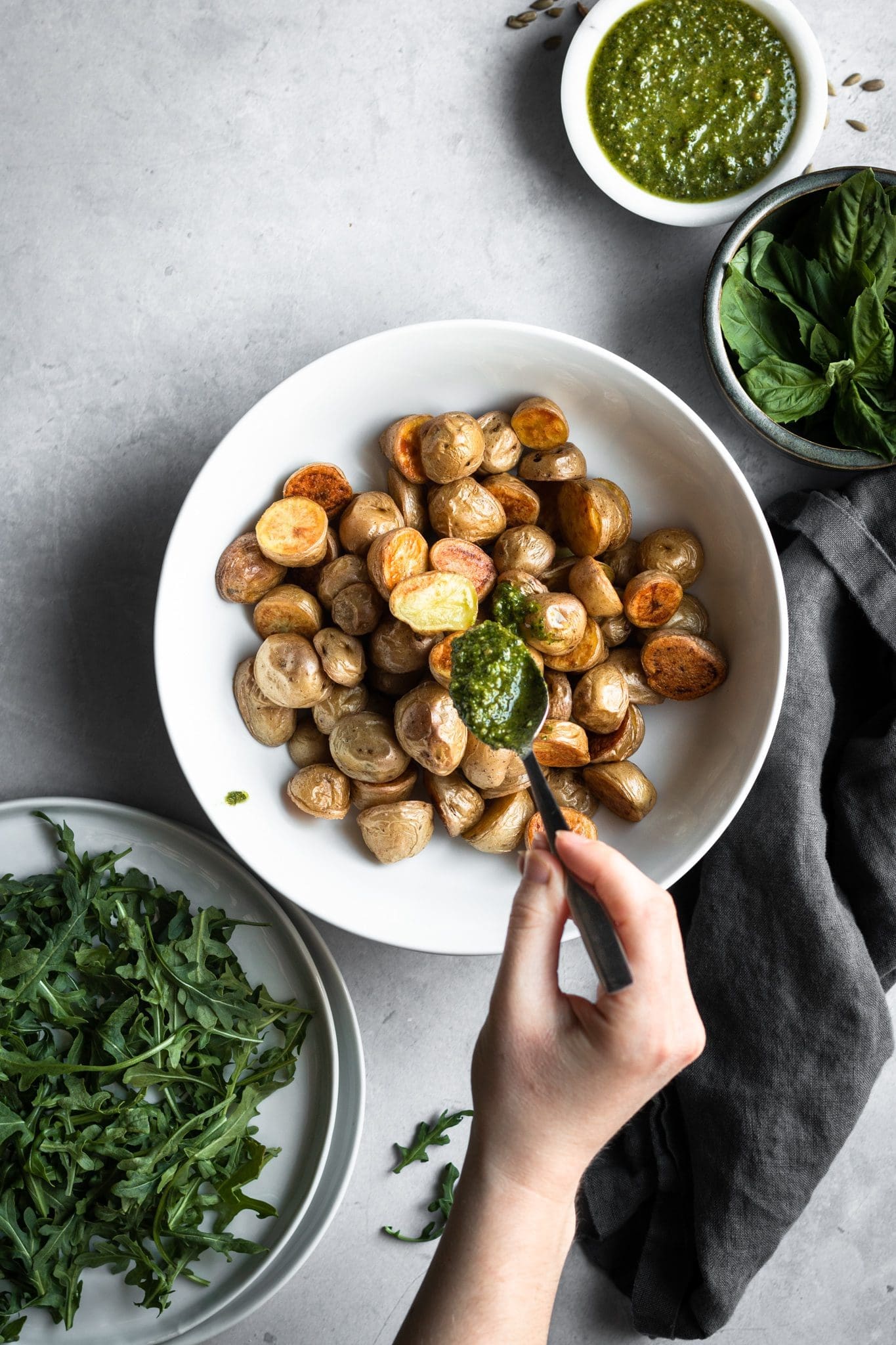 roasted potatoes in a bowl with pesto