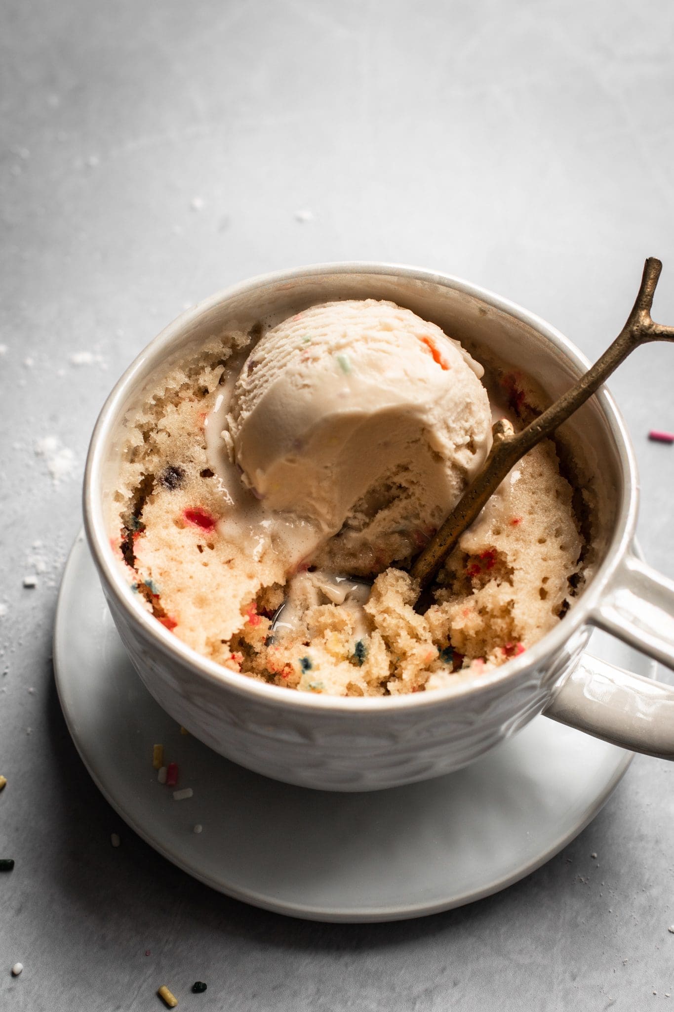 spoon in a mug cake with ice cream