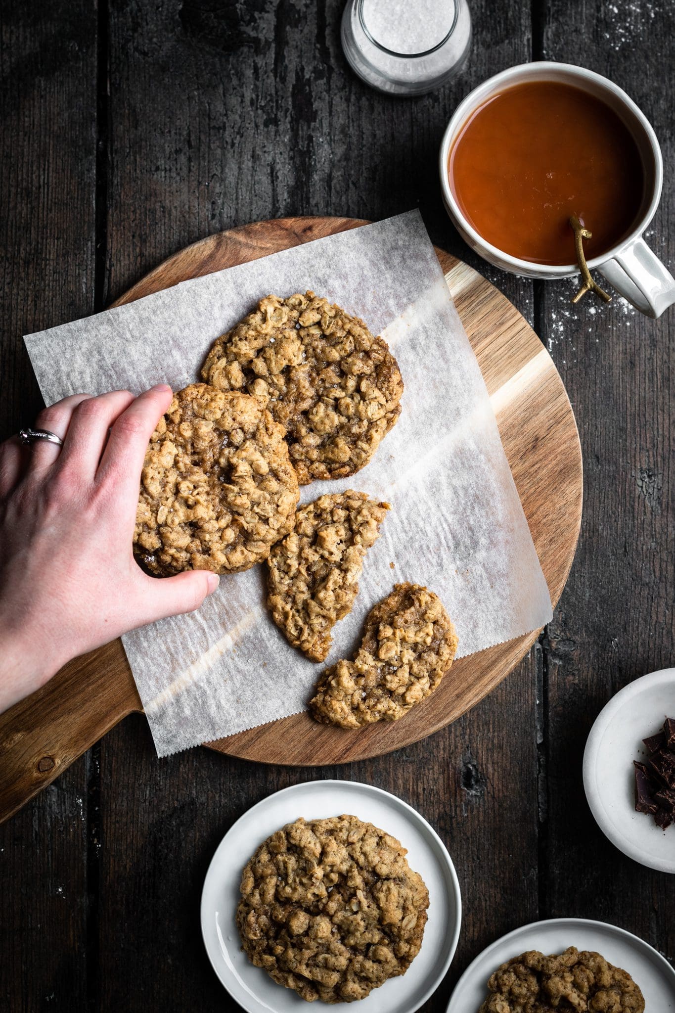 hand reaching for oatmeal cookie