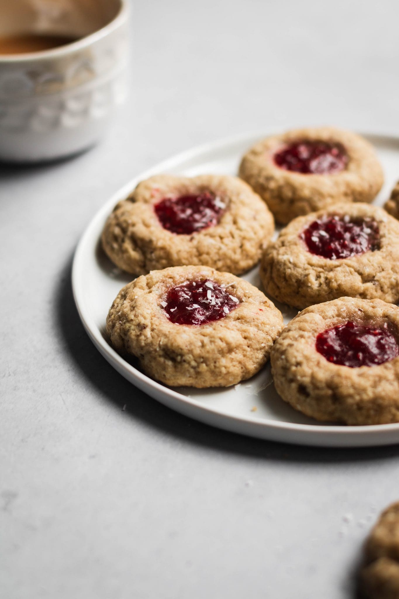 vegan raspberry thumbprint cookies on a plate