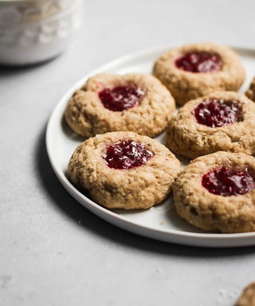 raspberry thumbprint cookies on a plate