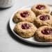 raspberry thumbprint cookies on a plate