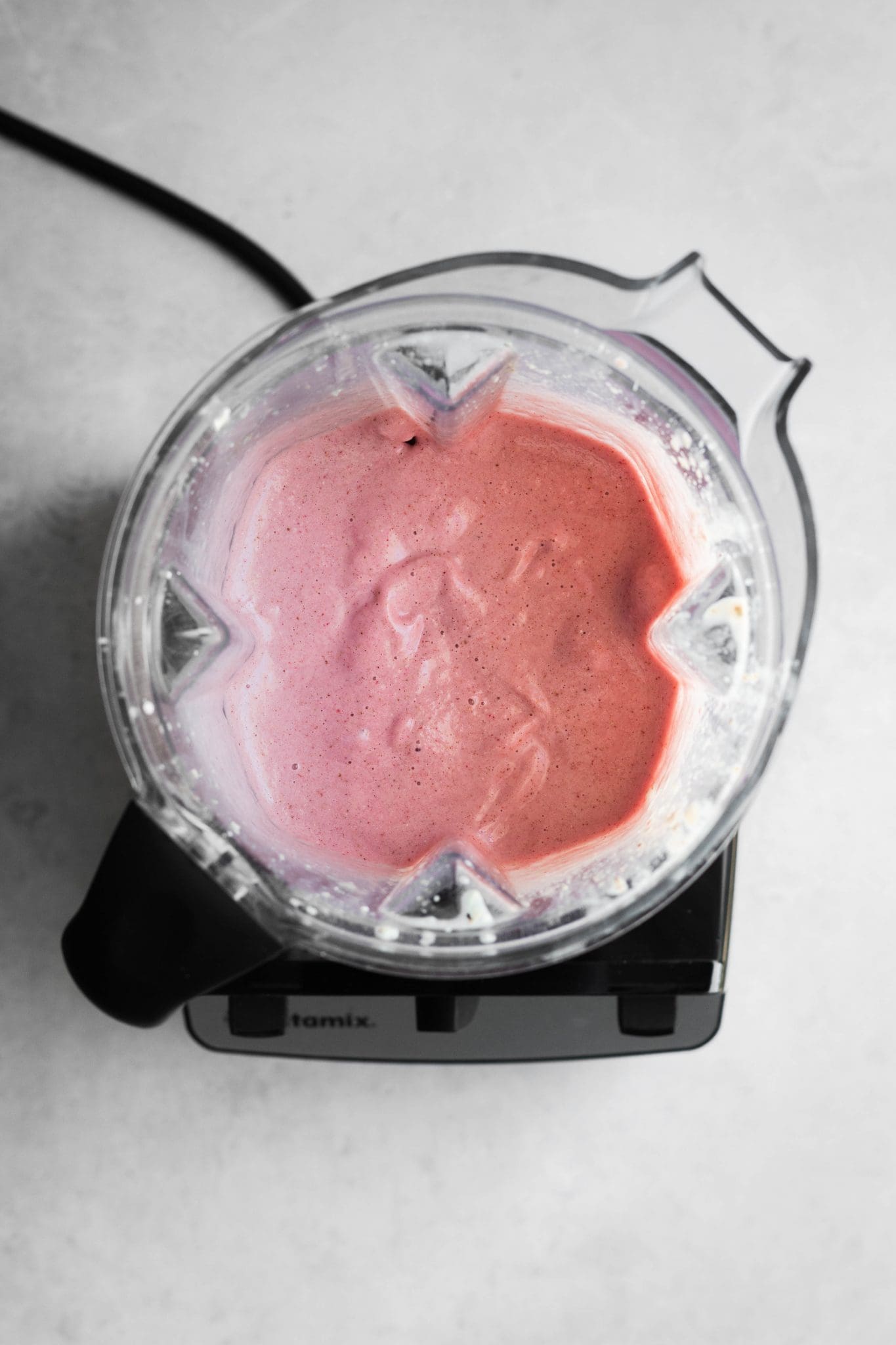 strawberry banana oat smoothie in a blender