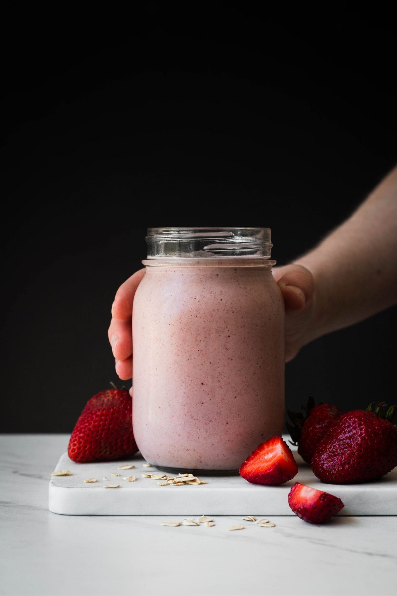 strawberry banana oat smoothie in a jar