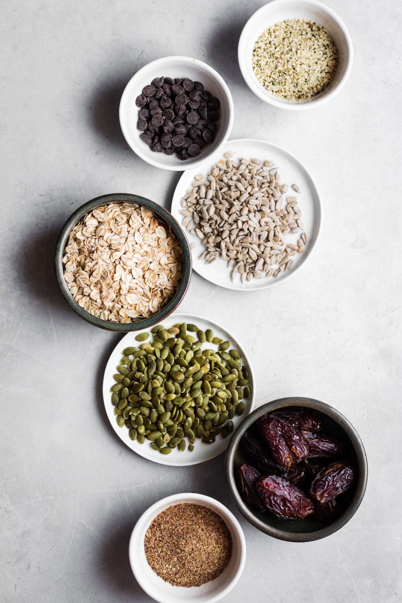 seeds, oats and dates in bowls