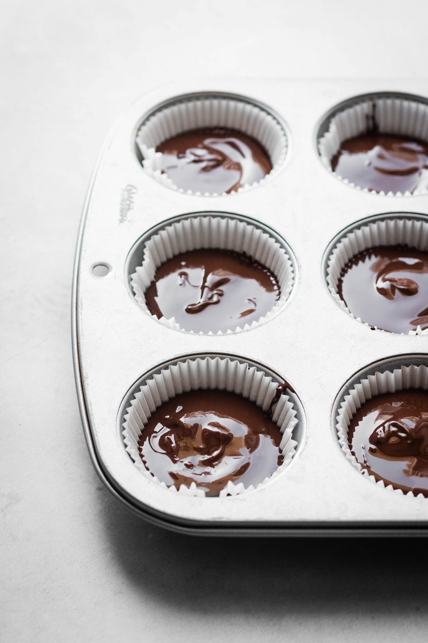 melted chocolate in muffin tins