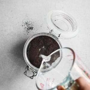 how to make cold brew coffee - water poured over coffee grounds