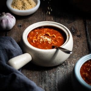 lentil lasagna soup with vegan parmesan sprinkled on top