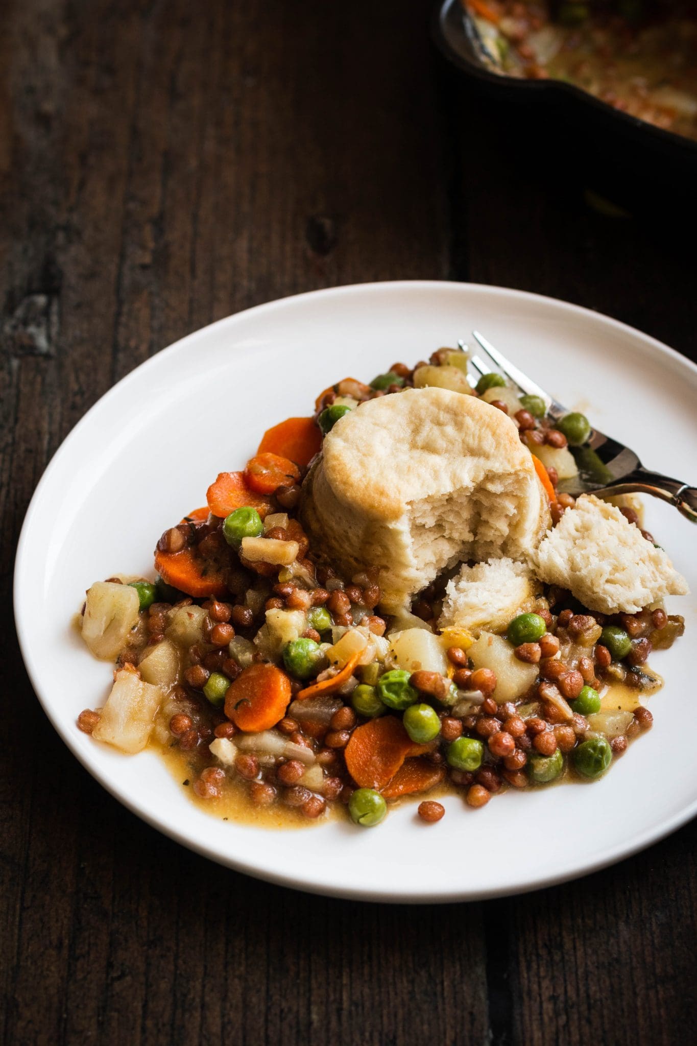 vegan lentil pot pie with biscuits on a plate