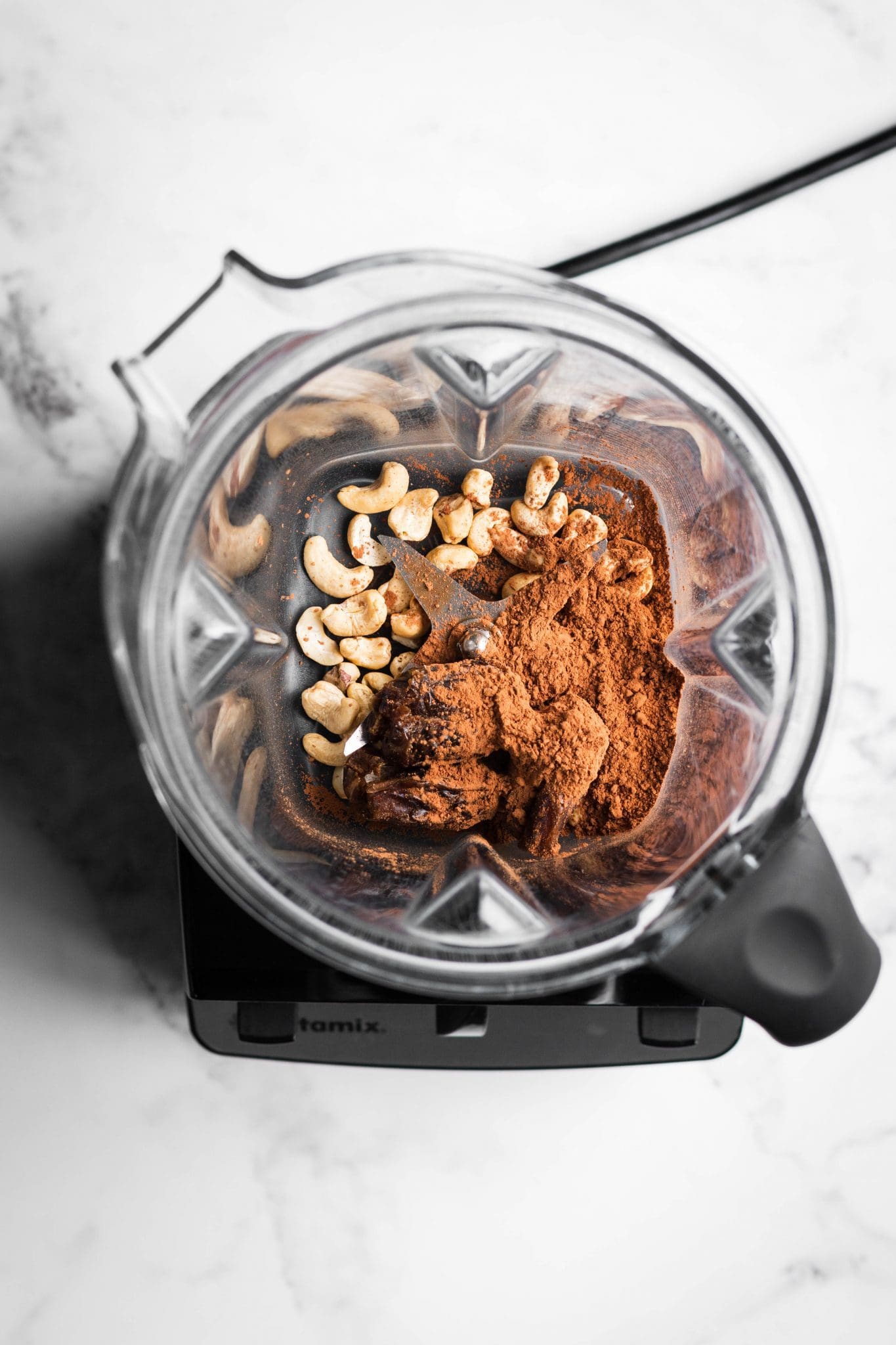 cocoa powder, dates and cashews in a blender