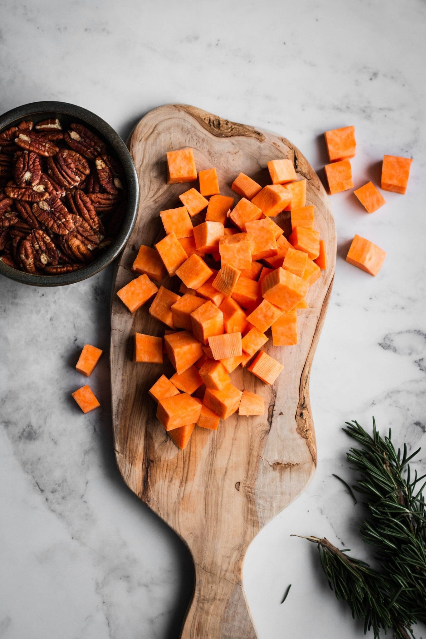 diced sweet potatoes on a cutting board