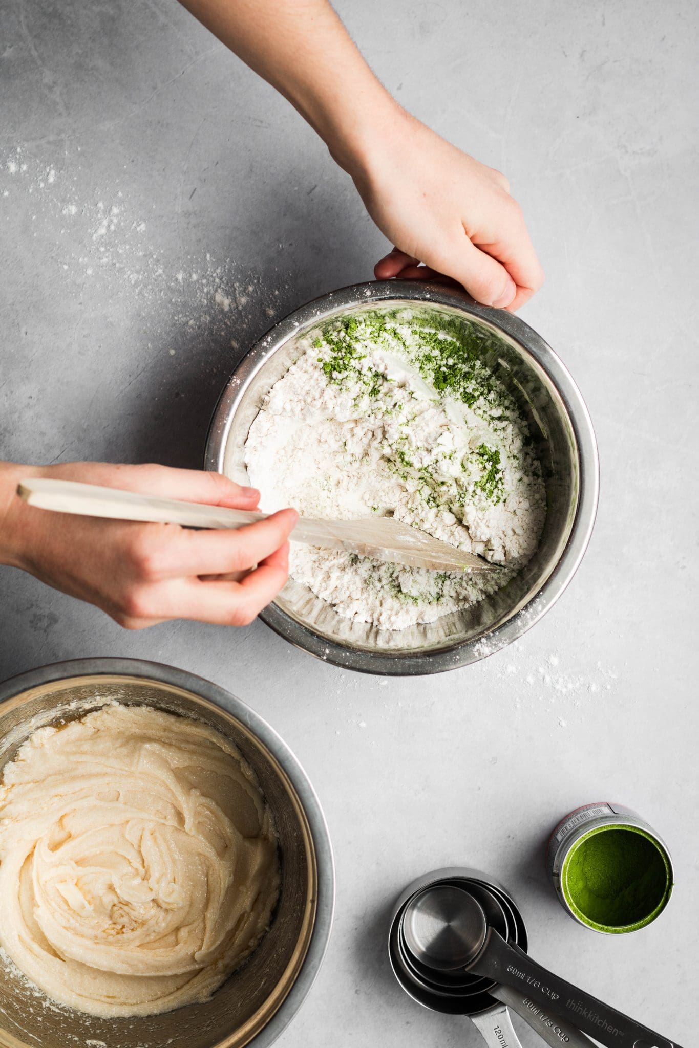 Hands mixing cookie ingredients in a bowl