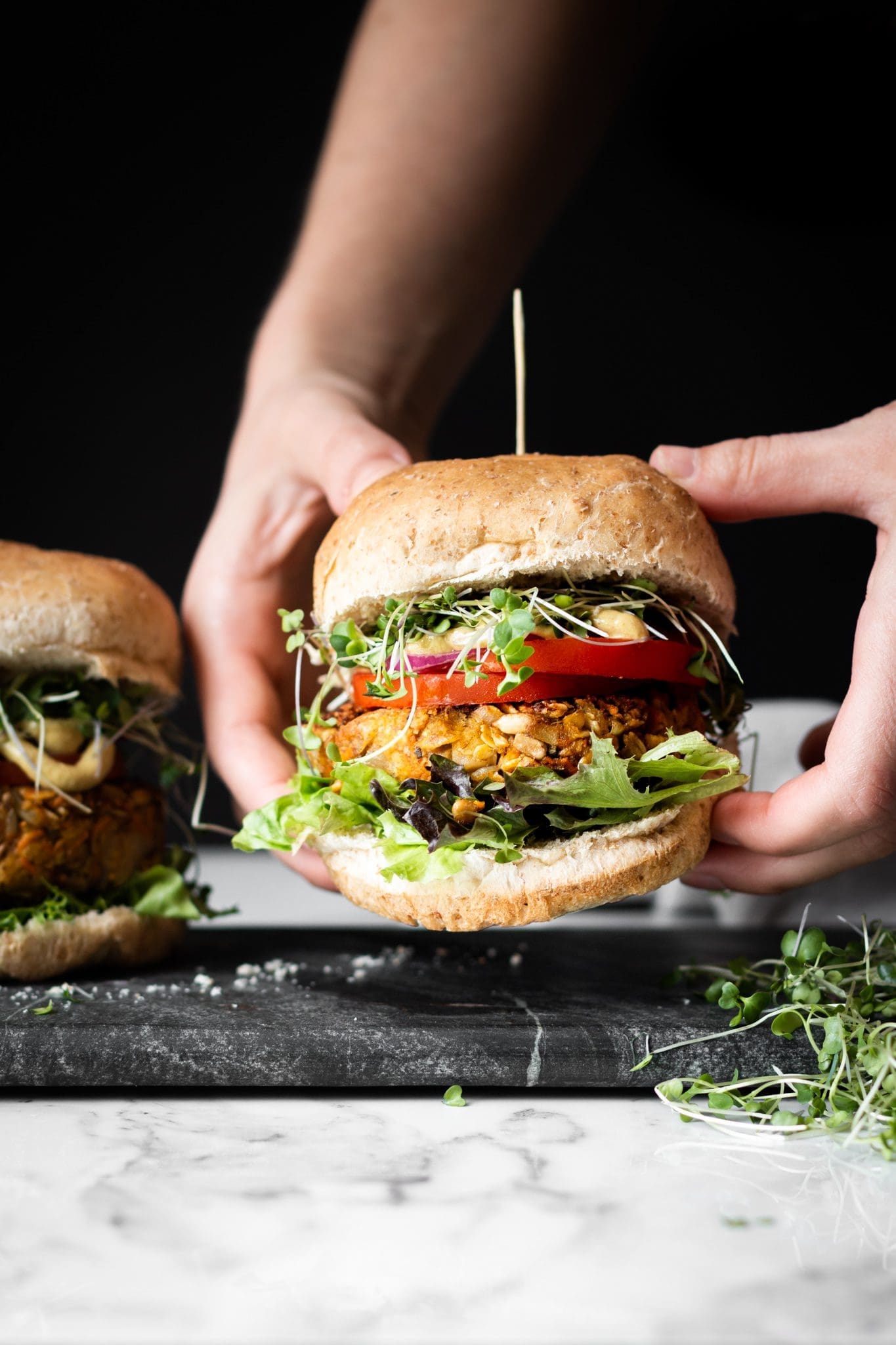 hands holding a veggie burger