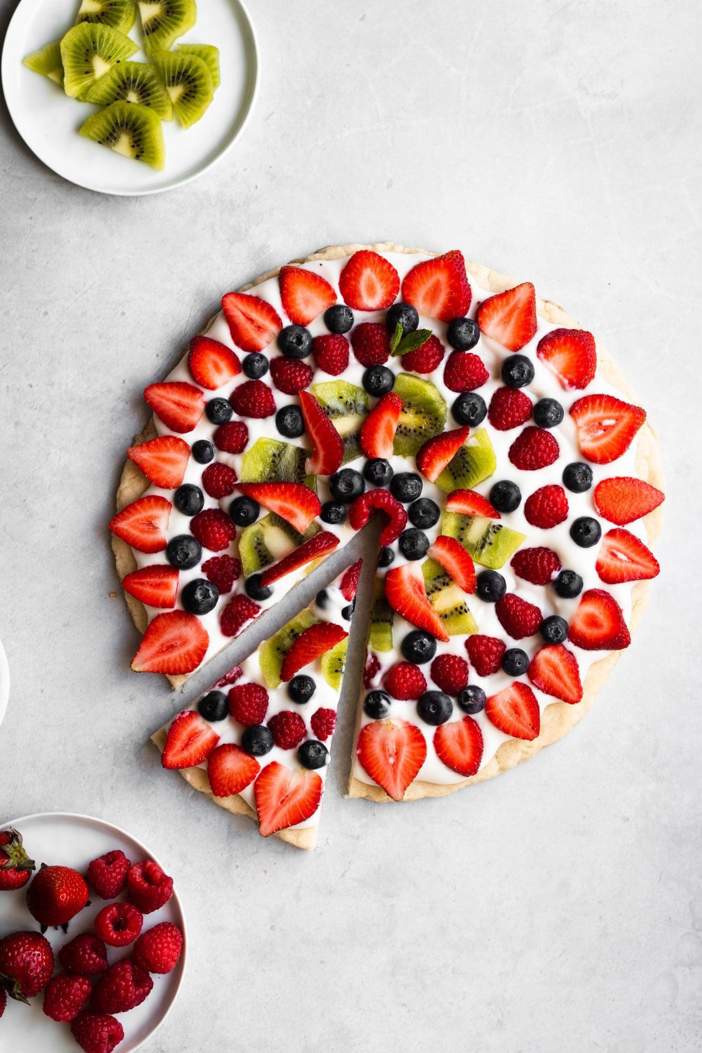 vegan fruit pizza from the top with one slice cut