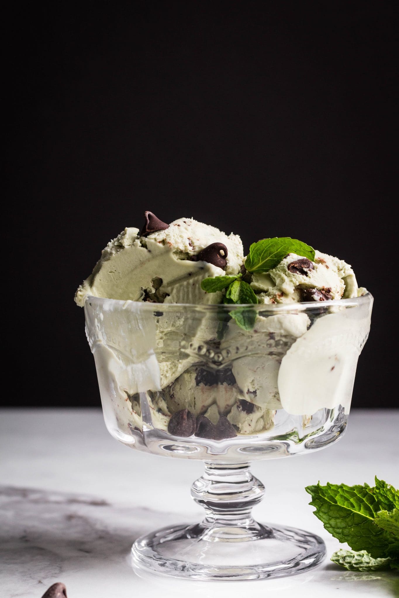 vegan matcha mint chocolate chip ice cream in a glass bowl