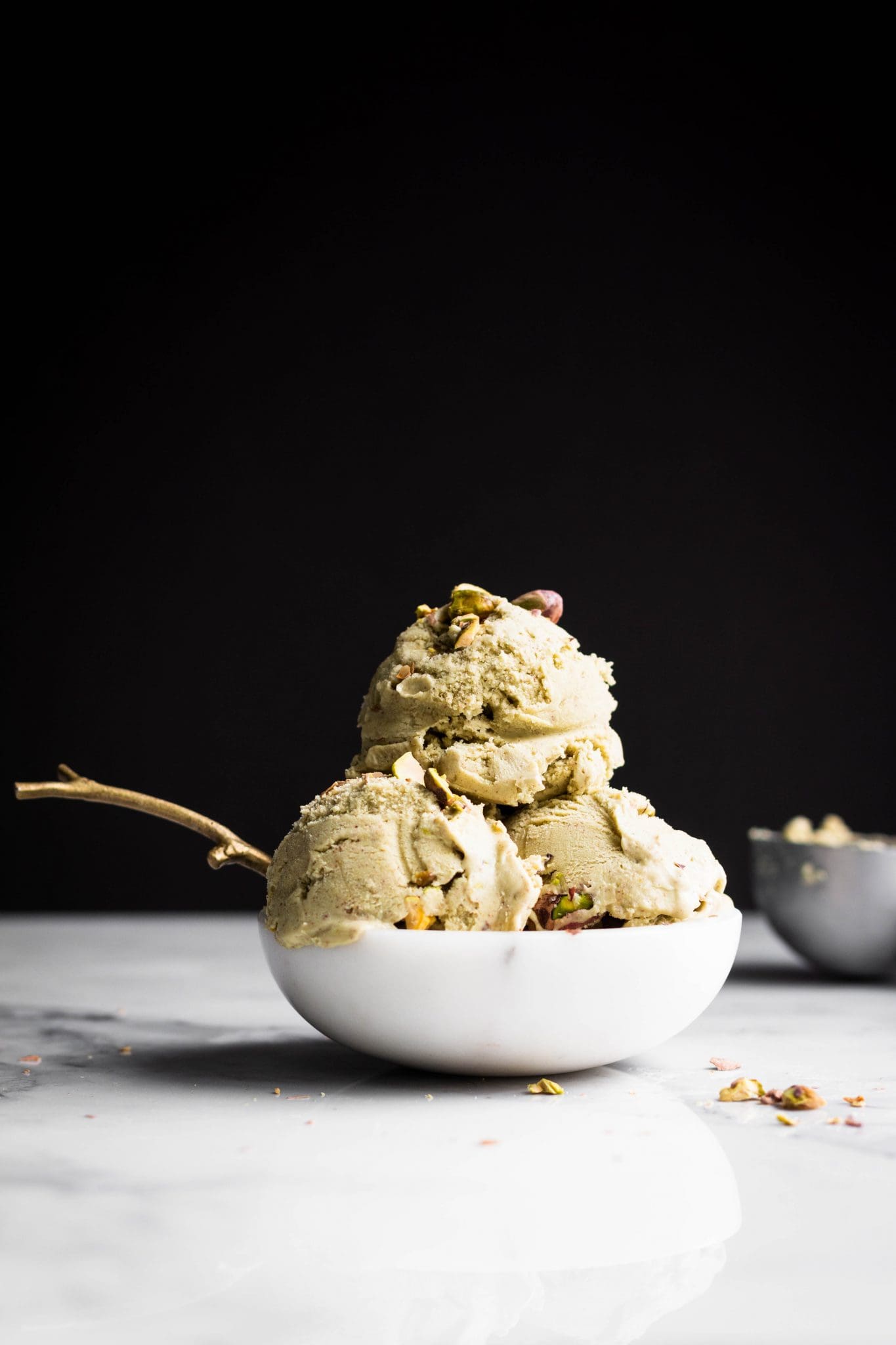 3 scoops of vegan pistachio ice cream in a boel