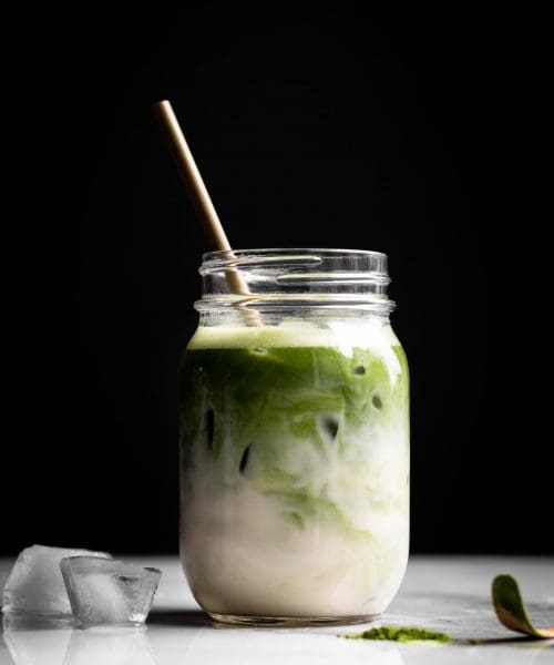 iced matcha latte with oat milk in a jar