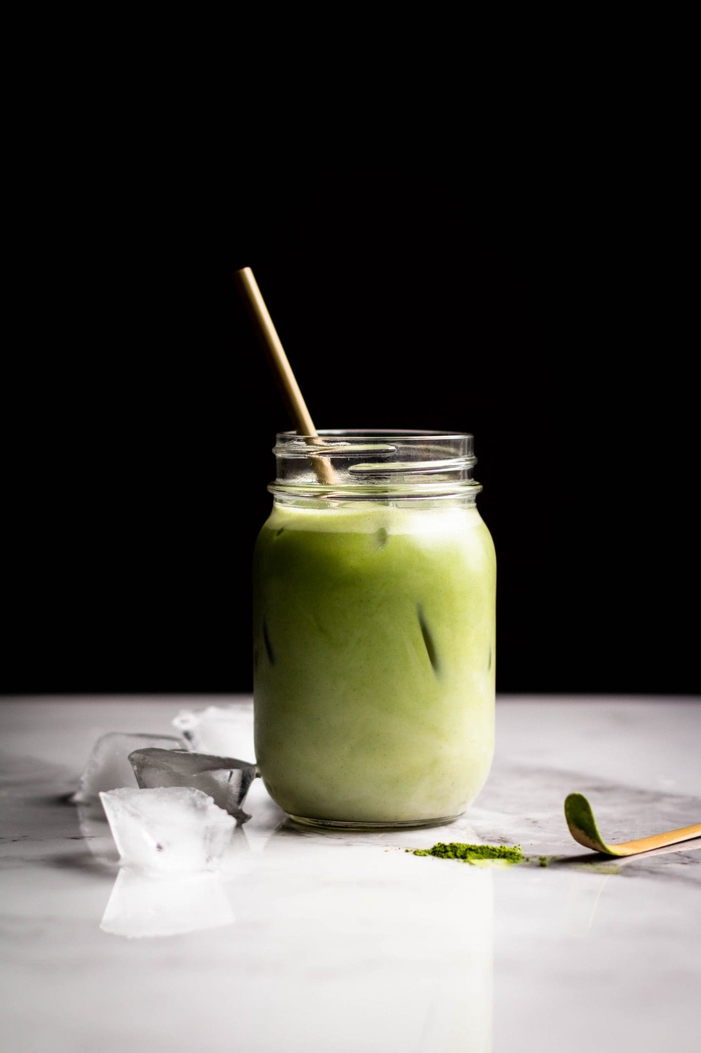 iced matcha latte with oat milk in a jar