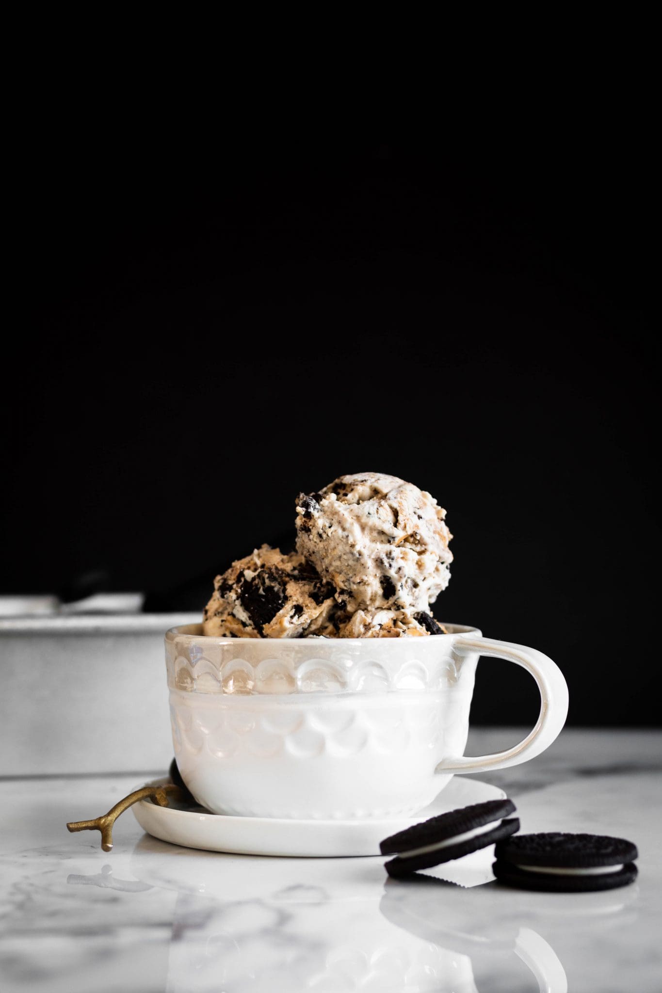 vegan cookies and peanut butter ice cream scoops in a cup from the side